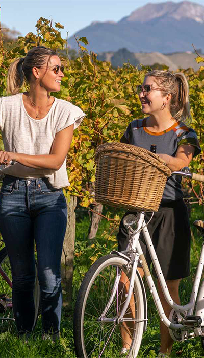 People sitting outside with bikes